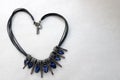 Heart made of female jewelry, necklaces with blue gems, diamonds, diamonds in the shape of a heart
