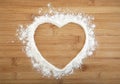 Heart made of flour on a wooden bamboo background