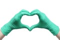 Heart made of green medical gloves isolated on white background