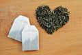 Heart made from loose leaf tea and tea bags on wooden background Royalty Free Stock Photo