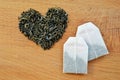 Heart made from loose leaf tea and tea bags on wooden background Royalty Free Stock Photo