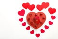 heart made of paper hearts laid out on a white background in the middle of a cardboard heart and glass hearts and a box with a Royalty Free Stock Photo