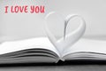 Heart made of paper sheets on book Royalty Free Stock Photo