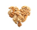 Heart made of peeled walnuts on white background