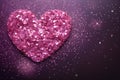 Heart made of pink confetti and glitter on dark purple background. Festive abstract backdrop Royalty Free Stock Photo