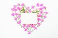 Heart made of pink flowers and envelope on white background. Valentine`s day. Flat lay, top view. Royalty Free Stock Photo