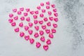 Heart made of pink plastic hearts on a white background Royalty Free Stock Photo