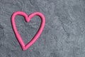 Heart made of play dough in front of grey background Royalty Free Stock Photo