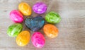 Heart made of precious stone on wood with colorful Easter eggs