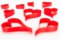 Heart made from red, satin ribbon isolated on white background. Valentines Day concept.