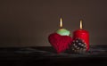 A heart made of red thread, a cone and two lit colored candles Royalty Free Stock Photo