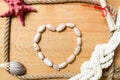 Heart made of seashells with border of ropes and knots on boards Royalty Free Stock Photo