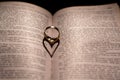 A heart made from the shadow of a ring on a book Royalty Free Stock Photo