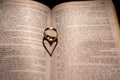 A heart made from the shadow of a ring on a book Royalty Free Stock Photo