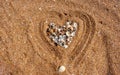 A heart made of shells on wet sea sand Royalty Free Stock Photo