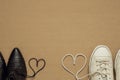 Heart made of shoelaces between men`s and women`s shoes, space for text, valentines day background Royalty Free Stock Photo