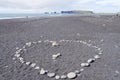 Heart made of small stones on sand, on the beach Royalty Free Stock Photo