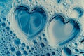 Heart made of soap foam with bubbles on blue background. Soap bubbles in bath or sud Royalty Free Stock Photo