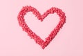 Heart made with sprinkles on pink background, top view Royalty Free Stock Photo