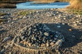 Heart made of Stone on beach with water in background Royalty Free Stock Photo