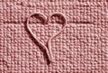 A heart made by an undone thread on a home carpet