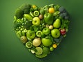 Heart made of various green vegetables and fruits isolated on green background. Green heart as a green life concept and healthy Royalty Free Stock Photo