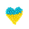 heart made of yellow and blue candy on a white background. Royalty Free Stock Photo