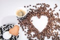 Heart make whit coffee beans and cup whit espresso and sweet heart cookie on white background.