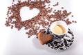 Heart make whit coffee beans and cup whit espresso and sweet heart cookie on white table background.