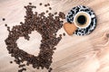 Heart make whit coffee beans and cup whit espresso and sweet heart cookie on wood table background.