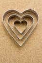 Heart, metal shape on pressed corkwood background. Conceptual photo