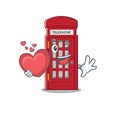 With heart miniature telephone booth above cartoon table Royalty Free Stock Photo