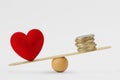 Heart and money on balance scale - Concept of love priority in life Royalty Free Stock Photo