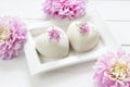 Heart mousse cakes covered with white chocolate velvet decorated of pink flowers