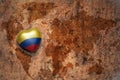 Heart with national flag of colombia on a vintage world map crack paper background.