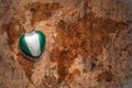 Heart with national flag of nigeria on a vintage world map crack paper background.