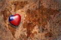 Heart with national flag of taiwan on a vintage world map crack paper background. Royalty Free Stock Photo