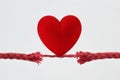 Heart on nearly broken rope - Concept of love and risk Royalty Free Stock Photo