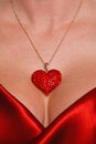 Heart necklace and red satin dress Royalty Free Stock Photo