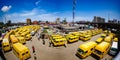 Obalende Bustop with Yellow Buses