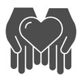 Heart in open hands solid icon. Love in arms vector illustration isolated on white. Help glyph style design, designed