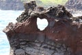 A heart opening carved out of volcanic rock near the Nakalele Blowhole in Poelua Bay, Maui, Hawaii Royalty Free Stock Photo
