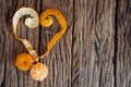 Heart with orange peel on wooden background. Royalty Free Stock Photo