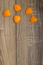 A heart of orange peel on wooden background Royalty Free Stock Photo