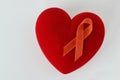 Heart with orange ribbon on white background - Concept of leukemia awareness, kidney cancer association, multiple sclerosis and