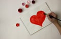 The heart is painted with red paint on a white sheet of paper