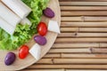 Heart of palm (palmito) with cherry tomato on cutting board Royalty Free Stock Photo