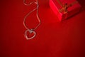 Heart pendant on a red satin background Royalty Free Stock Photo