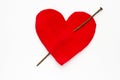 Heart pierced with rusty nail over white background Royalty Free Stock Photo