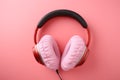 Heart pillow and headphones on pink background love songs/podcast